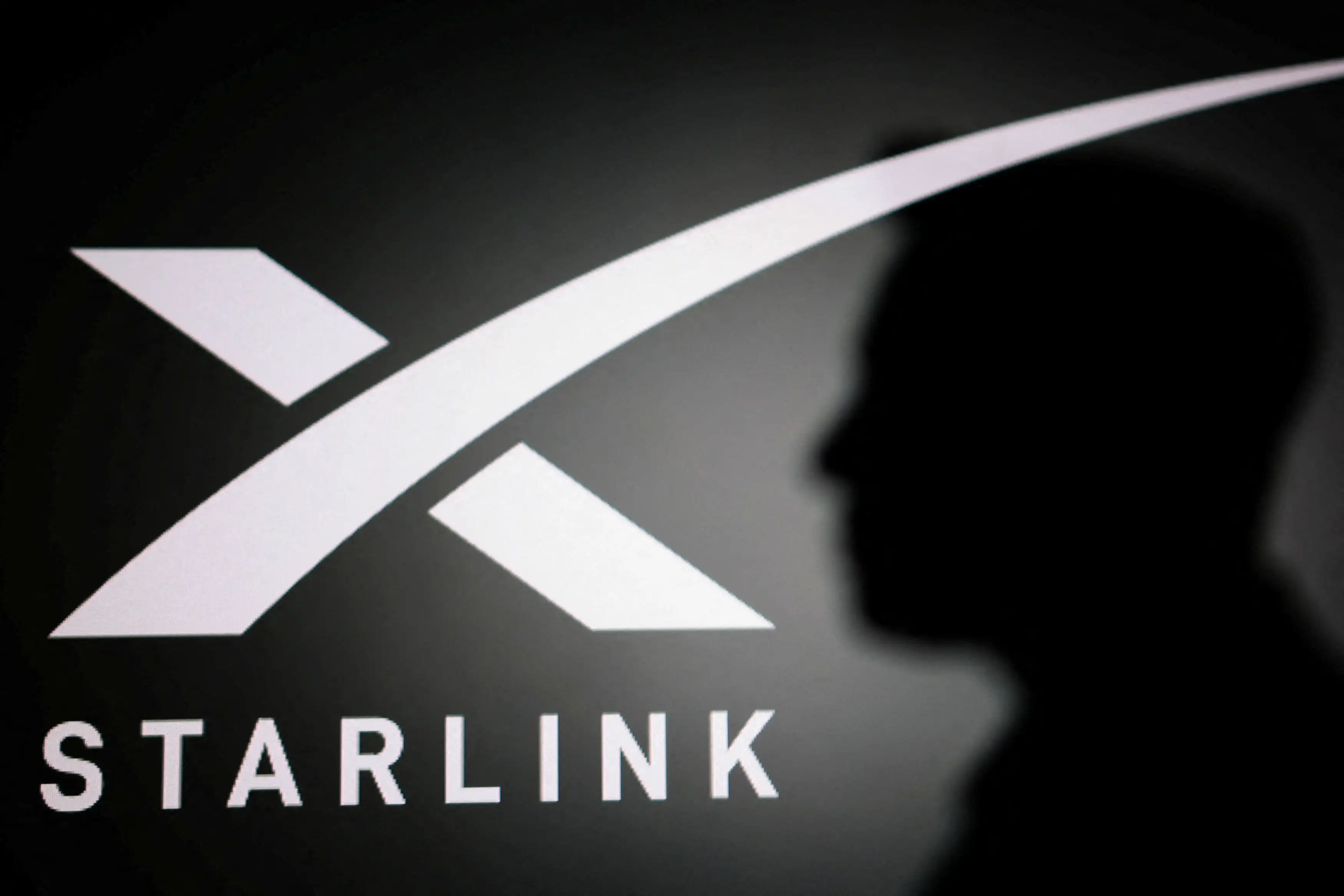The silhouette of Elon Musk and Starlink logo are seen in this illustration taken June 11, 2026. The silhouette of Elon Musk and Starlink logo are seen in this illustration taken June 11, 2026.